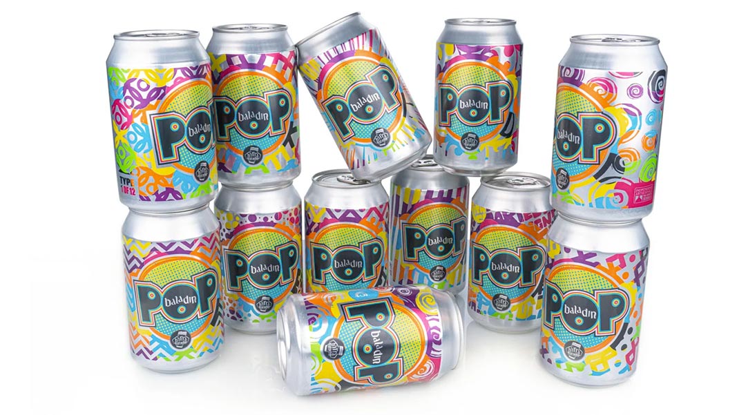 Multiple cans stacked in a group with multicolored printed soda can designs