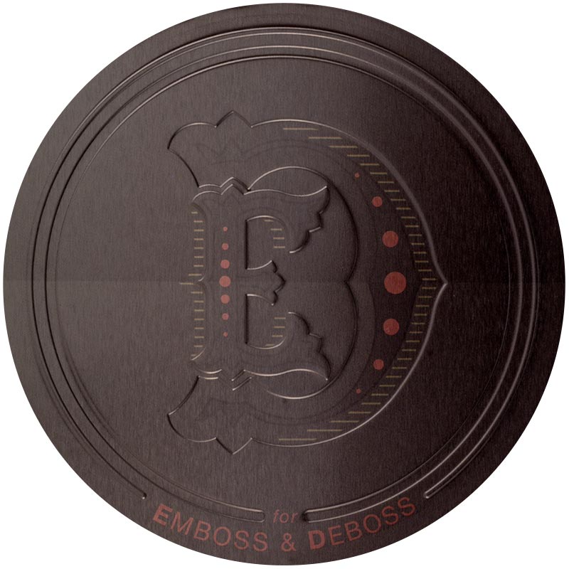 A tin lid with the letters "E" and "D" engraved into it in a gothic font. The tin reads: "E & D for Emboss & Deboss"