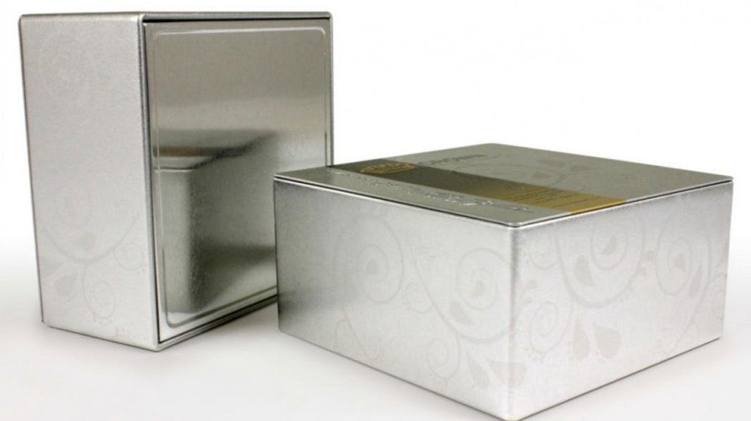 Two tins with fancy engravings on them