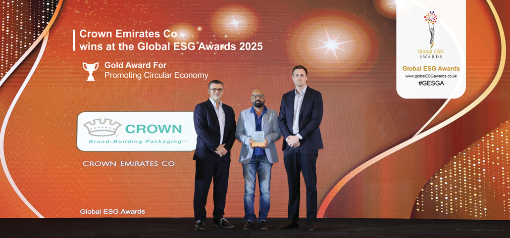Three men standing in front of large background annoucing Crown Emirates Co as winner of Gold Award for Promoting Circular Economy