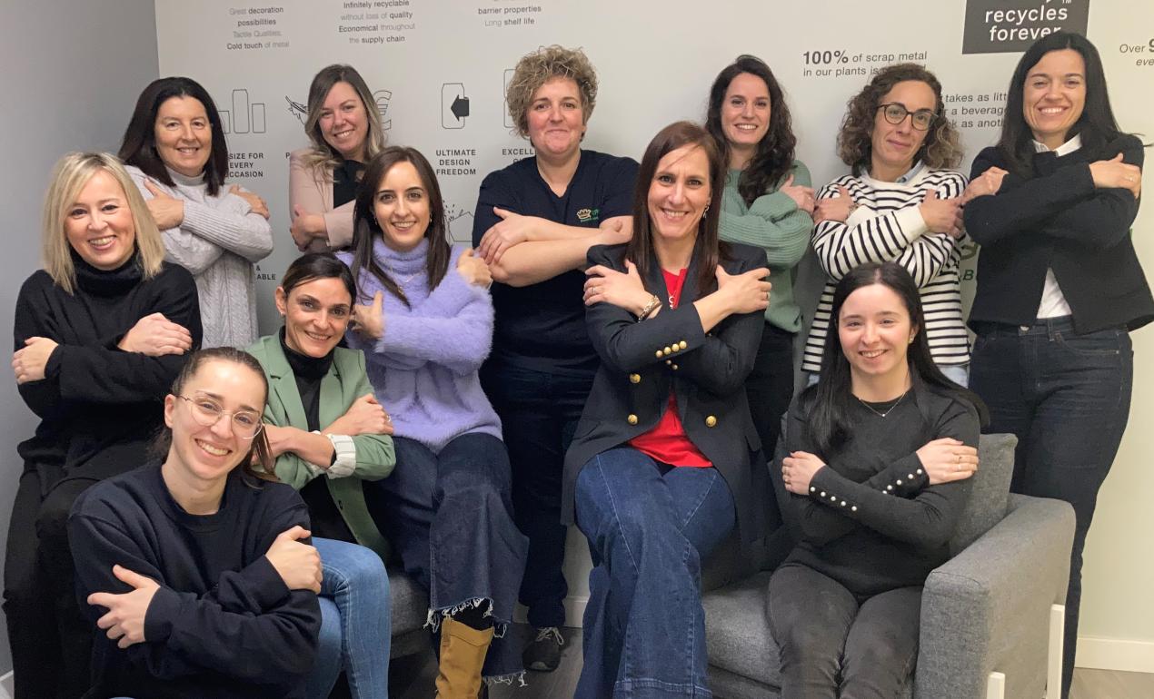 Women in a group in an office setting folding arms