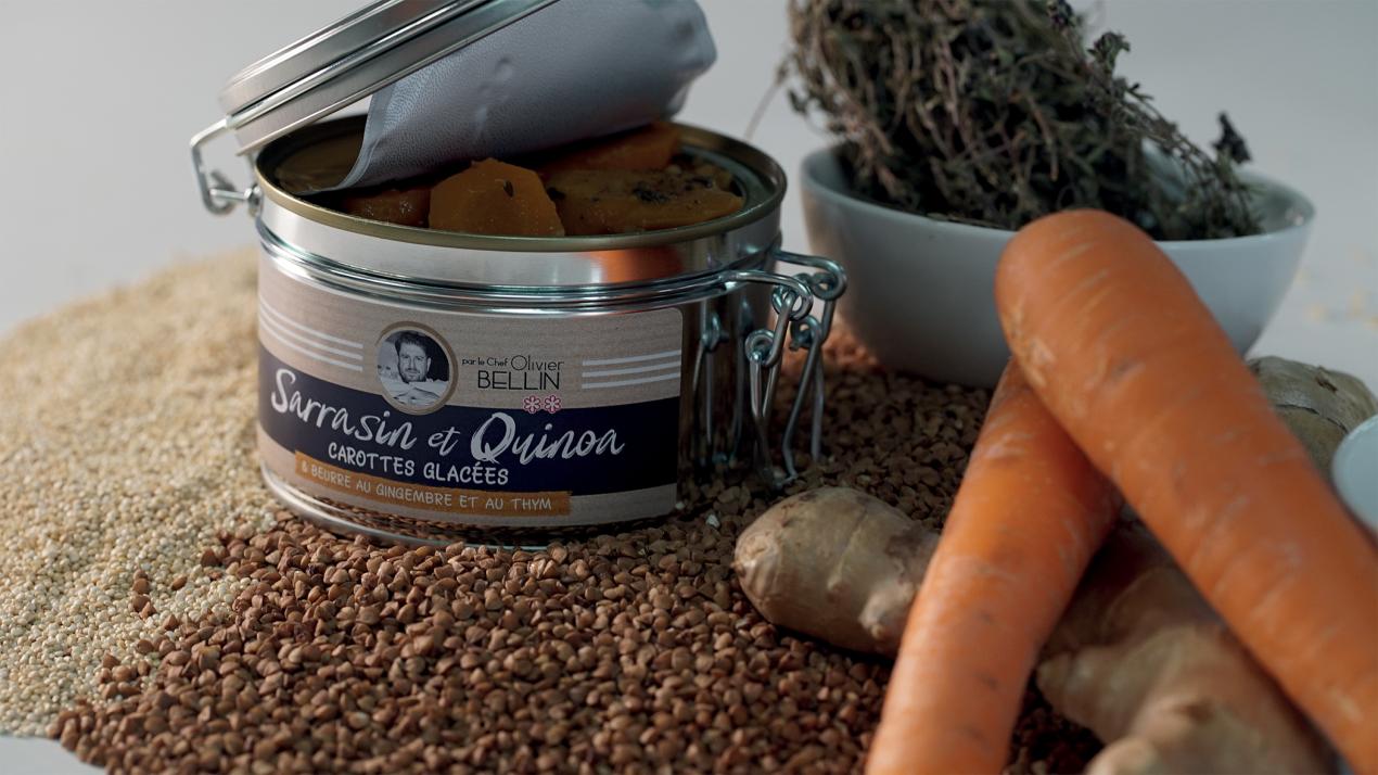 An opened can of quinoa sitting next to carrots and other vegetables
