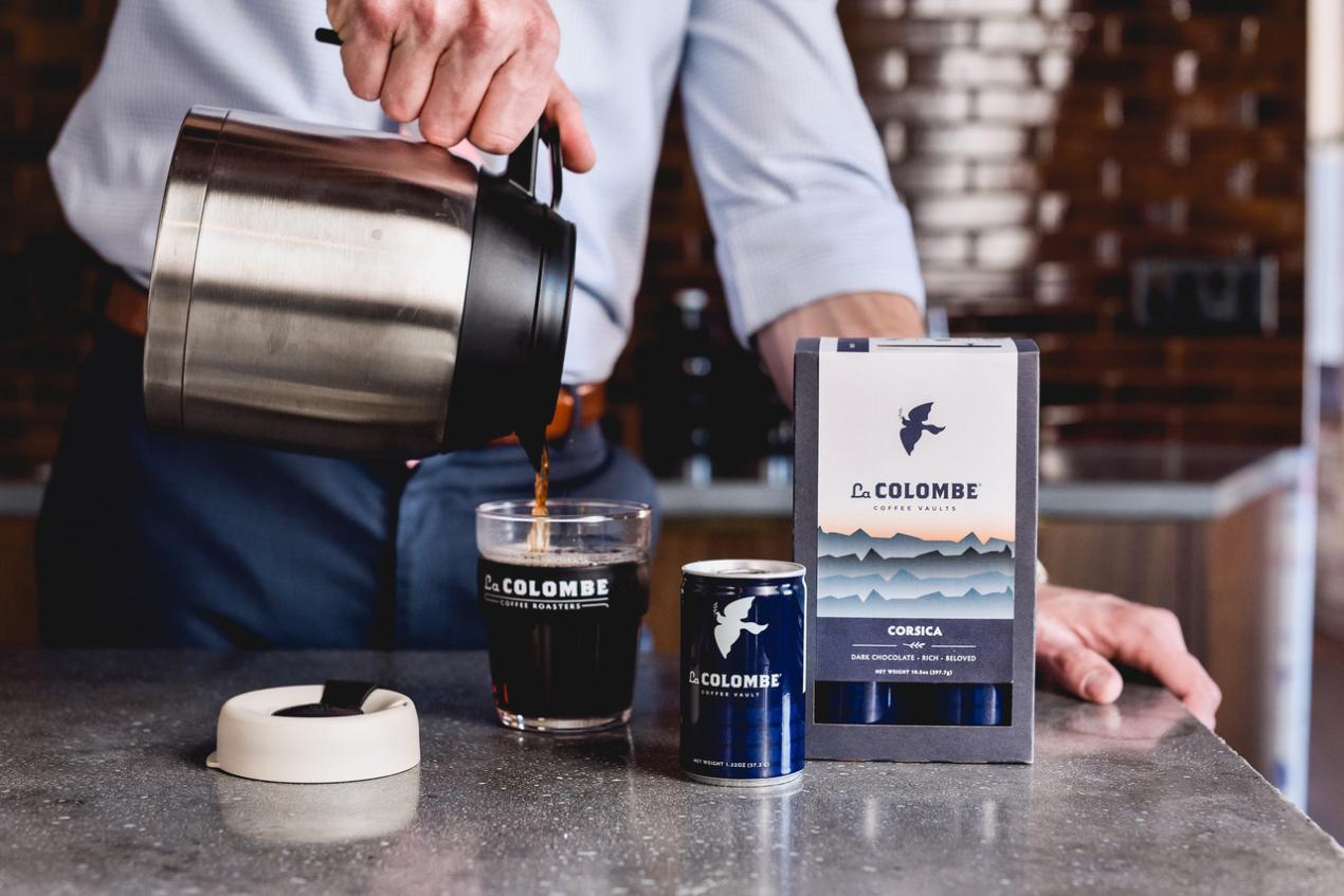 man pours cup of La Colombe coffee