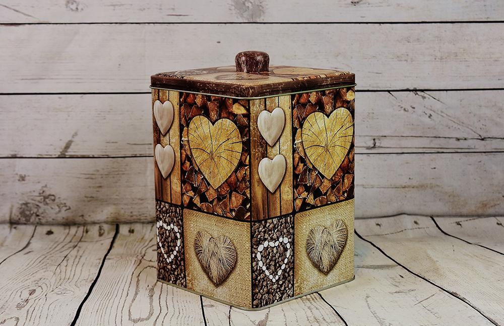 Square-shaped decorative food can with heart shapes on the sides.