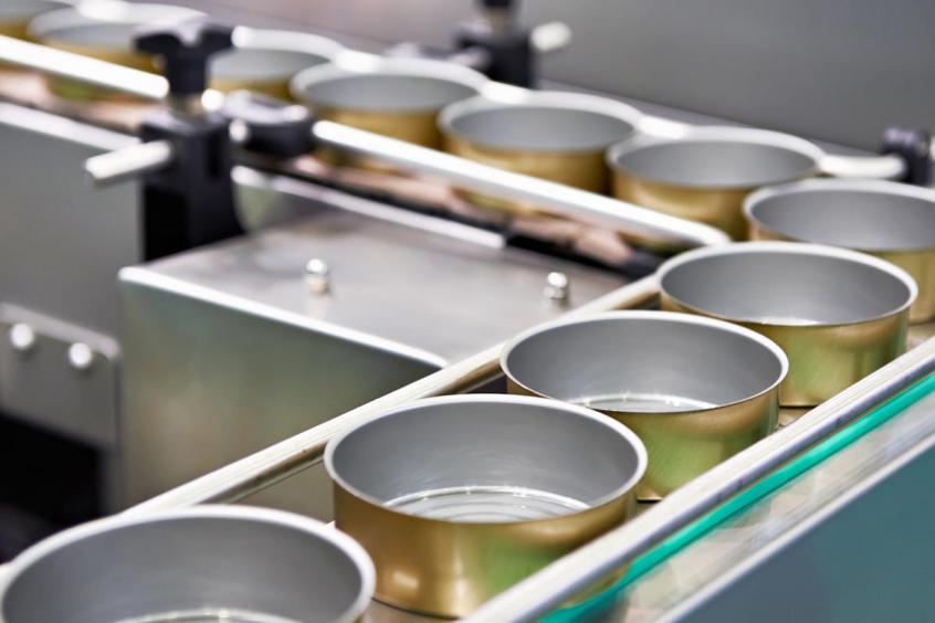 Empty cans on the conveyor of a food factory
