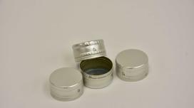 A pile of silver aluminum caps for bottles